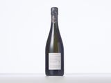 a bottle of white wine sitting on top of a table