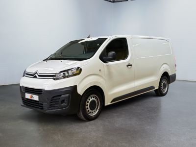 the white van is parked in a large room with a ceiling fan