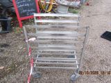 a metal rack that has a chalk board on top of it