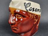 a ceramic head of a man with a hat on