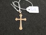 a close up of a cross on a string with a price tag