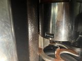 a close up of a coffee maker with coffee beans in it