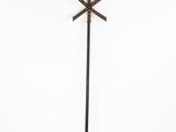 a tall metal pole with a cross on top of it