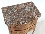 a small marble topped table with a drawer on it