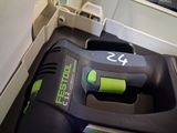 a black and green corded electric tool in a box