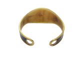 a close up of a gold cuff with a black stripe on it