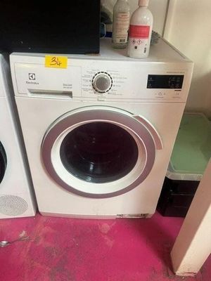two washing machines sitting next to each other on the floor