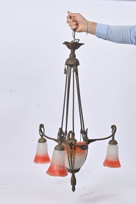 a man that is holding a chandelier in his hand