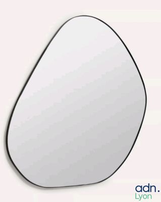 a mirror that has a tear shaped shape on it