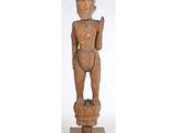 une vieille statue en bois d'un homme avec un chapeau sur la tête