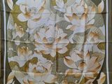 a close up of a square scarf with flowers on it