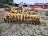 a close up of a tractor plow sitting in a field