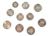 a close up of a bunch of coins on a white surface