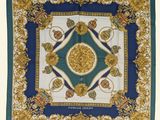 a blue and white square scarf with a gold medallion design