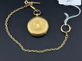 a close up of a gold pocket watch on a chain