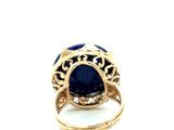 an image of a gold ring with a blue stone surrounded by filigree filigree