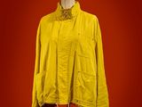 a yellow jacket on a mannequin stand against a red background