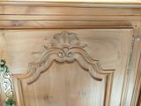 a close up of a wooden cabinet with a door handle