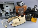 many different types of cameras and equipment sitting on a table
