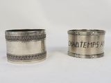 two antique silver napkins with engraved names on them