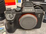 a sony camera sitting on a table next to some other cameras