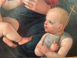 a painting of a woman holding a baby with a cross on it
