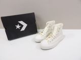 white converses with a black box and white converses on a white table