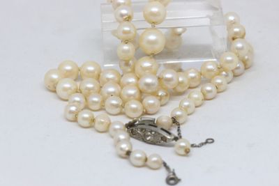 pearl necklace with a silver clasp and a white pearl bead
