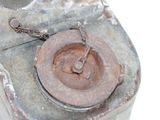 a rusted metal object with a chain attached to it