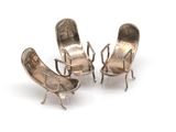 pair of silver plated chairs with arms and legs