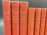 six orange books sitting on top of each other on a table