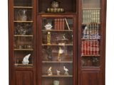 a wooden cabinet with glass doors and a clock on top of it