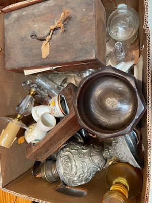 a box full of antique items on the floor