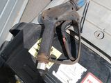 a gas pump that is sitting on top of a suitcase