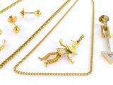 several pieces of gold jewelry are displayed on a white surface