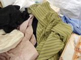 a suitcase full of clothes sitting on top of a bed