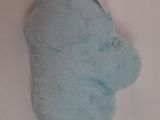 a blue stuffed animal that is laying on a white surface