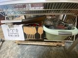 a metal rack with various kitchen utensils on it