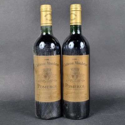 two bottles of wine sitting next to each other on a table