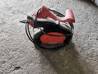 a red and black shoe that is on the floor