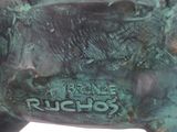 statue of a bull with a tag on it ' s back