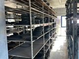 a room with a lot of shelves filled with pots and pans