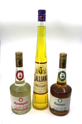 three bottles of alcohol are lined up on a white surface