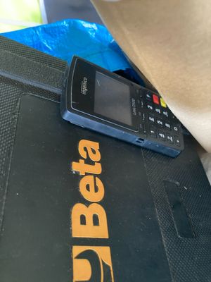 a cell phone that is sitting on top of a laptop