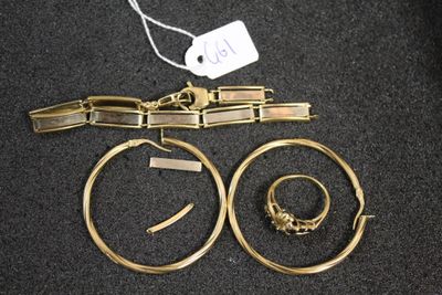 two gold rings and a bracelet are on a black surface