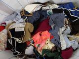 a basket full of clothes that is sitting on the floor