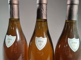 three bottles of wine sitting next to each other on a table