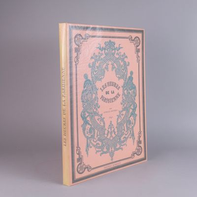 an old book sitting on top of a table next to a gray wall