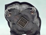 a metal sculpture of a bear with a diamond on it ' s back
