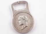 bottle opener shaped like a coin with a man ' s face on it